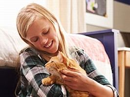 girl with orange cat in bedroom